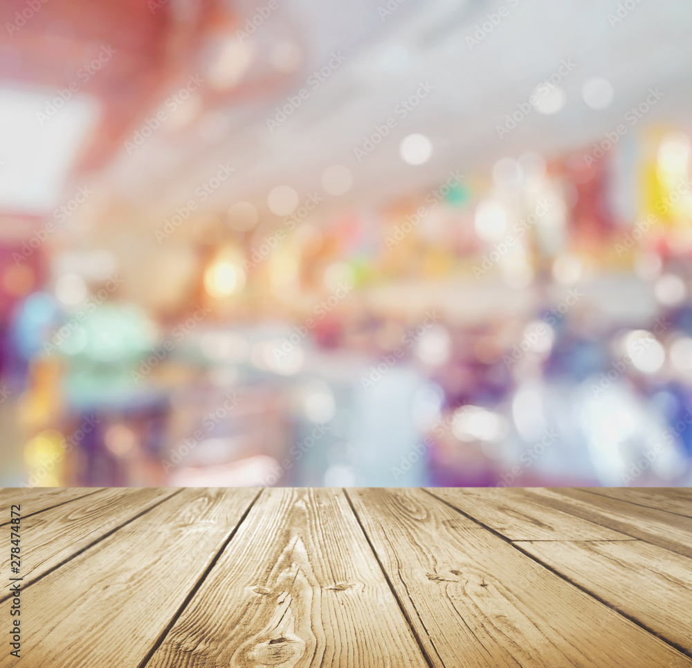 Rustic wood table with blurred bokeh restaurant background Rustic wood table with blurred bokeh restaurant background