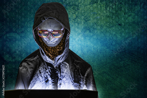 Bild auf Leinwand Mannequin and laptop in dark tone for cyber crime content.