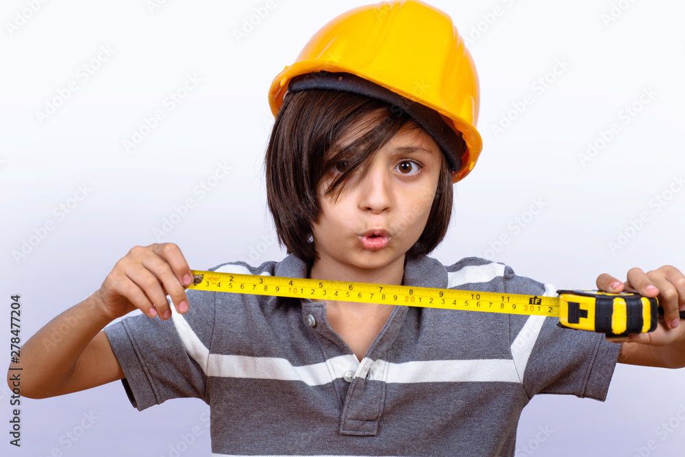 Little boy with helmet and holding measuring tape. Little boy with helmet and holding measuring tape.