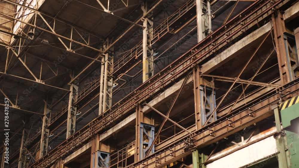 Old industrial hall with metal beams under ceiling in large heavy plant Old industrial hall with metal beams under ceiling in large heavy plant