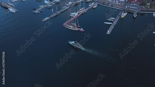A luxury yacht arrives at Sandhamn marina, a town on the Stockholm Archipelago. Aerial drone shot photo