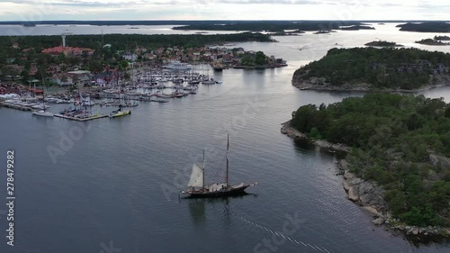 Aerial shot of a beautiful sailing ship moored near the marina of Sandhamn, Sweden at the start of the annual round Gotland boat race. photo