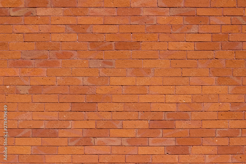 Naklejka premium Traditional vintage reddish orange brick wall texture background with weathered and worn bricks