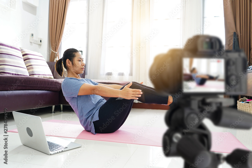 Asian women exercise workout at home, With recording making video blogger camera for their blog Asian women exercise workout at home, With recording making video blogger camera for their blog