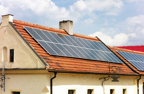 Contrast of the old house and modern technology as it is using solar roof