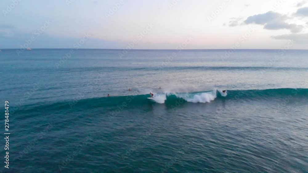 Drone Tracking Shot of Pro Surfer doing Carve, Turns and Cutback Tricks at Golden hour in Hawaii. Drone Tracking Shot of Pro Surfer doing Carve, Turns and Cutback Tricks at Golden hour in Hawaii.