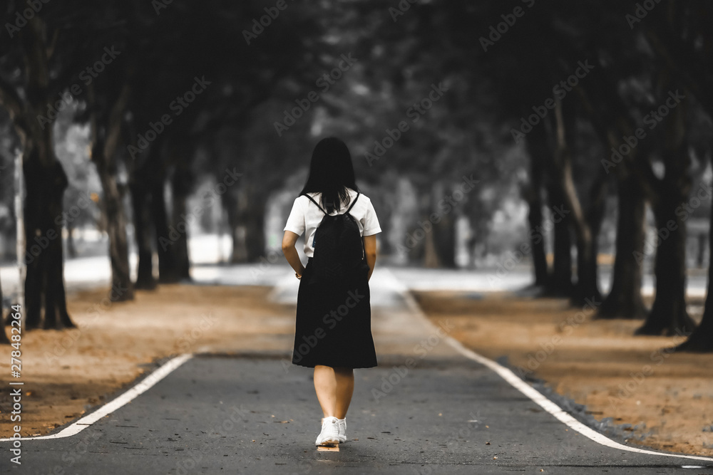 Portrait Of Female Teenage University student uniform between the tree Portrait Of Female Teenage University student uniform between the tree