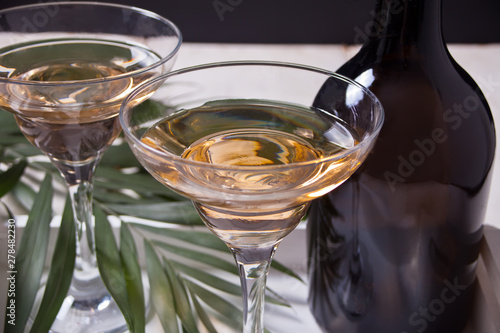 White wine in a glasses, bottle on the white wooden background. Dinner for two. photo