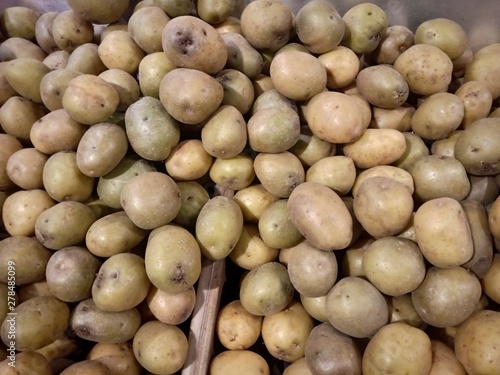 New harvest of sweet ripe potatoes on market close up