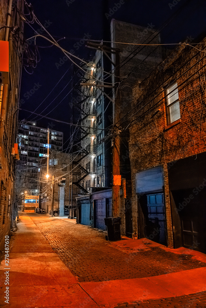 Vintage cobblestone brick city alley at night in Chicago
