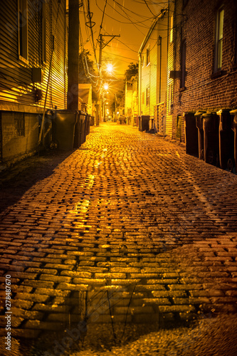 Vintage cobblestone brick city alley at night in Chicago