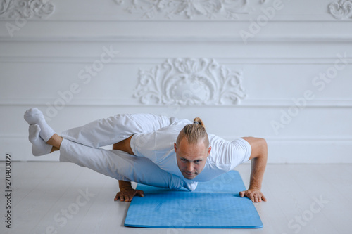 Man doing yoga at home. fitness, yoga and healthy lifestyle concept