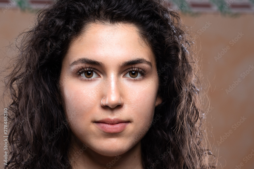 A close up view on the pretty face of a young Caucasian female. She wears minimal makeup over her pale complexion. Copy space on the right. A close up view on the pretty face of a young Caucasian female. She wears minimal makeup over her pale complexion. Copy space on the right.