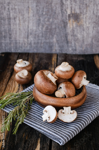  Brown mushrooms on old dark wooden background