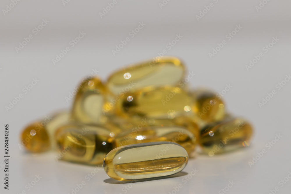Omega fat capsules on white background