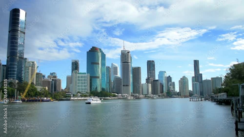 Classic view of central Brisbane from across the river, with the sun accenting the modern city highrises as a river ferry sails through the foreground Classic view of central Brisbane from across the river, with the sun accenting the modern city highrises as a river ferry sails through the foreground