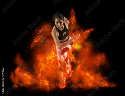 Woman running on fire background