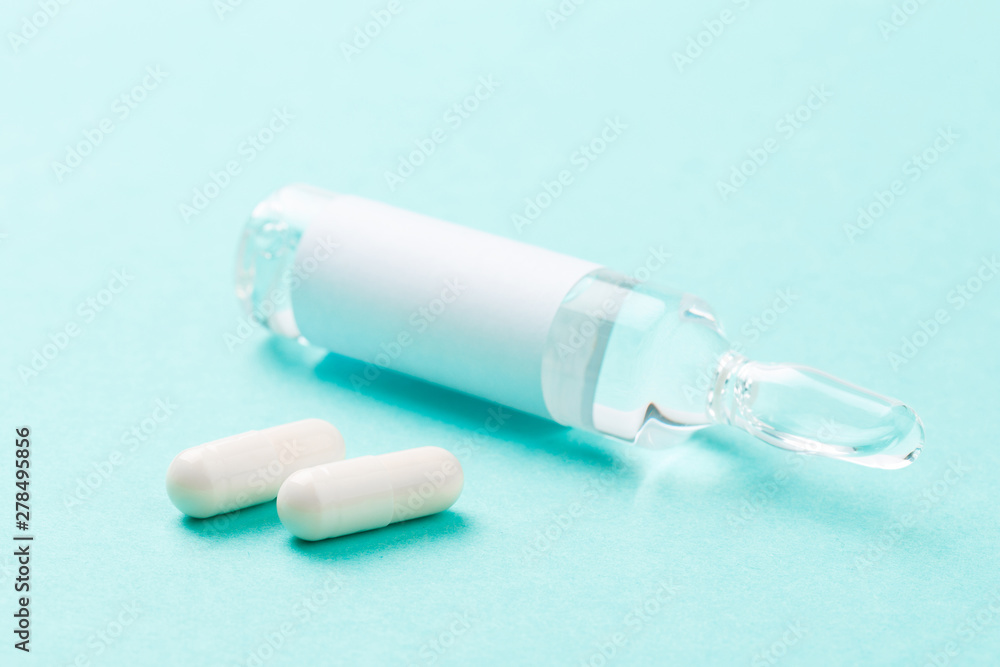 Set of vial bottles and pills on blue background. Medicine, health care and pharmaceutical drugs concept.- Image Set of vial bottles and pills on blue background. Medicine, health care and pharmaceutical drugs concept.- Image