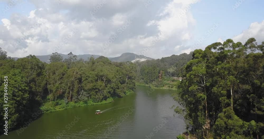 Boat Passing through a river surrounded by forest. Drone Aerial Footage Boat Passing through a river surrounded by forest. Drone Aerial Footage