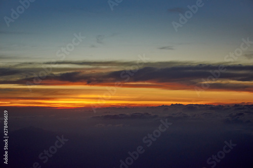 orange sky and clouds from an airplane window during an evening flight. © grit.wattanapruek