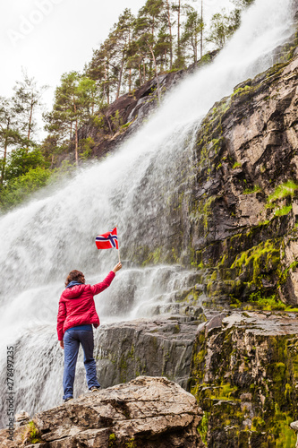 Tourist woman at waterfall Svandalsfossen, Norway
