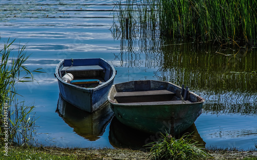  two old wooden boats on the shore