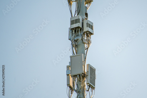 5g modern tv and smartphone telecommunication station antenna against the sky in the city