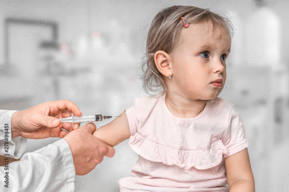 Pediatrician doctor is injecting vaccine to shoulder of baby Pediatrician doctor is injecting vaccine to shoulder of baby