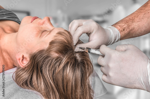 Woman with hair problem is receiving injection