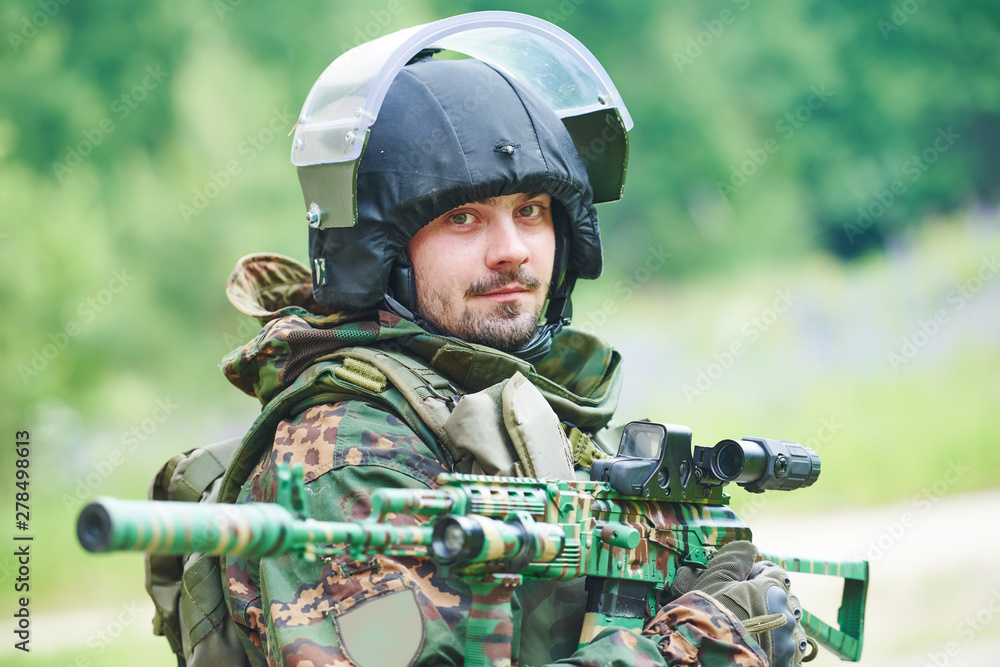Military soldier portrait with machine gun and protective clothing Military soldier portrait with machine gun and protective clothing
