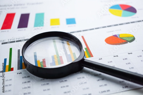 Magnifying glass on charts graphs paper. Financial development, Banking Account, Statistics, Investment Analytic research data economy