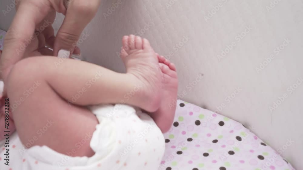Newborn Baby in Cradle Close Up Details and Mothers Hand Touching Her Newborn Baby in Cradle Close Up Details and Mothers Hand Touching Her