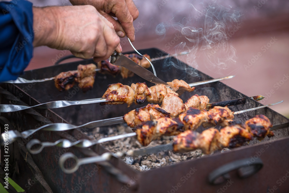 Cooking shashlik on the mangal in nature. Selective focus. Cooking shashlik on the mangal in nature. Selective focus.