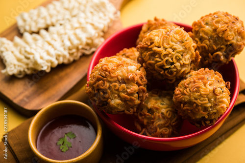 Crispy Noodles/maggie Pakora or pakoda is a popular indochinese street food served with ketchup photo