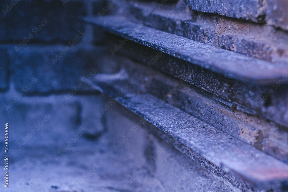 Old brick fireplace with rusted steel rails Old brick fireplace with rusted steel rails
