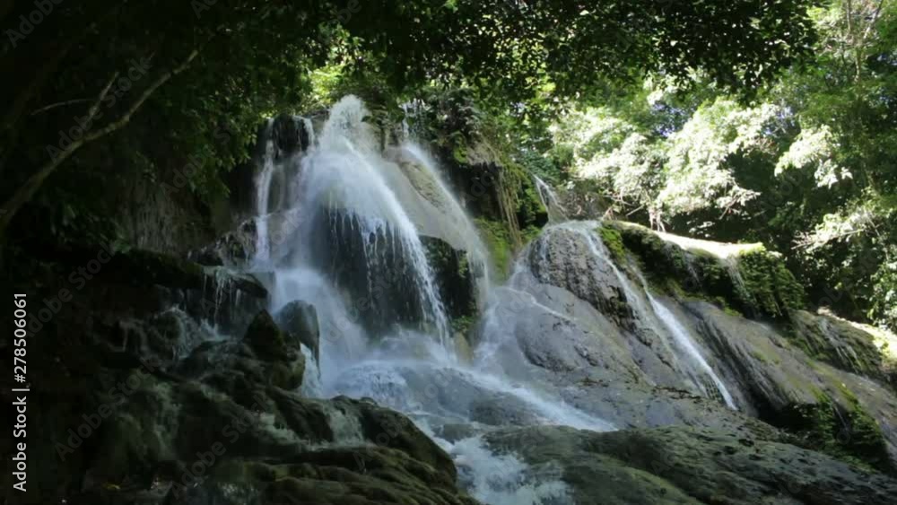 a large flowing waterfall in rainforest a large flowing waterfall in rainforest