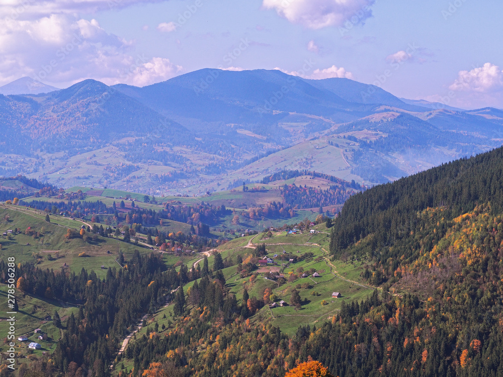 Fototapeta premium Carpatian village at mountains at the sunny day