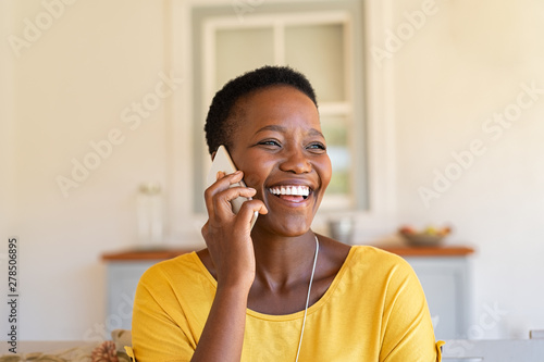 Woman laughing while talking on phone