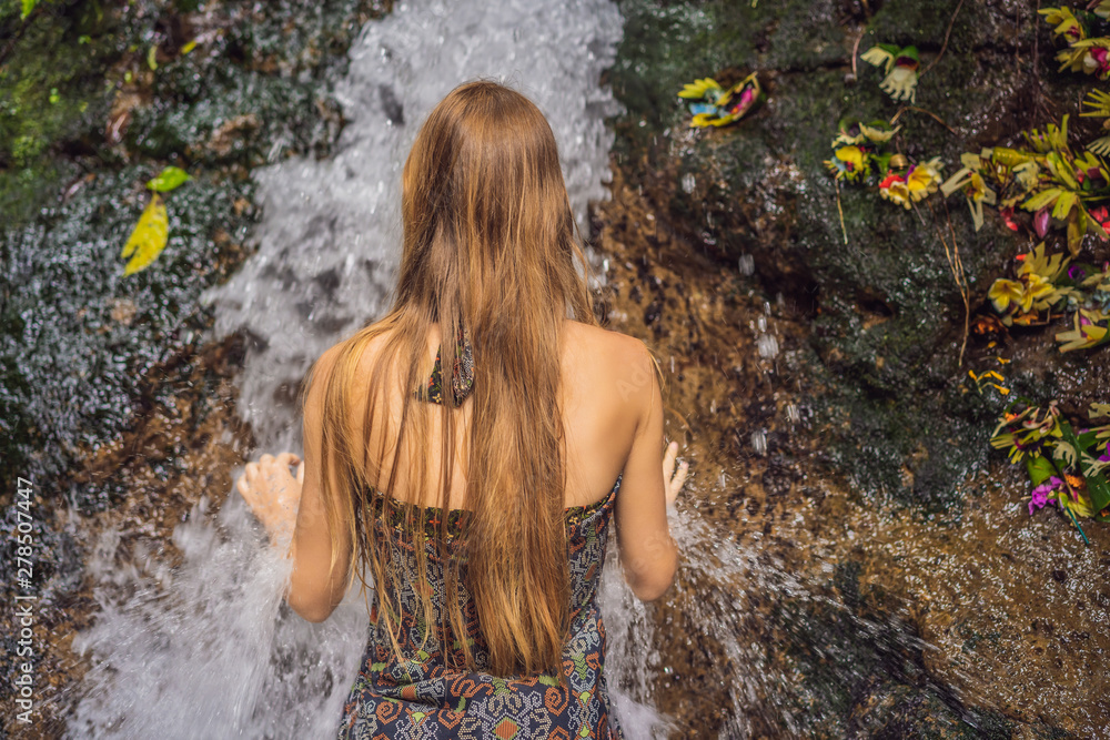 Young woman tourist in Holy springs Sebatu in Bali Young woman tourist in Holy springs Sebatu in Bali