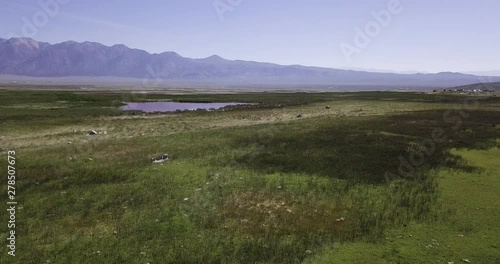 Whitmore Hot Springs, greenery of the campsite with tents and hot spring water drone dolly in low altitude shot photo