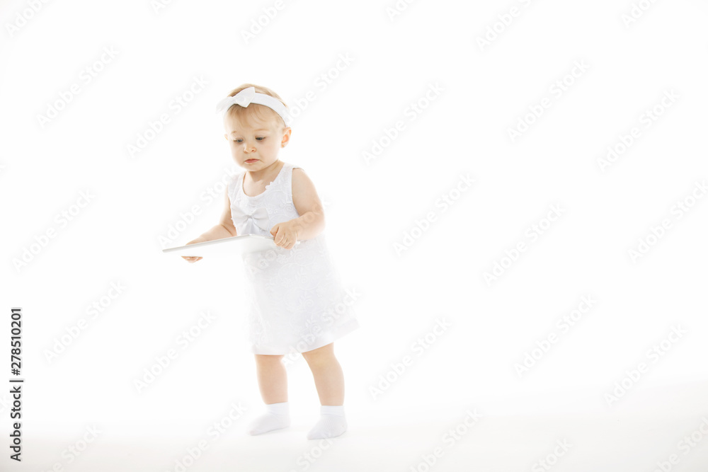 little girl all in white with a tablet little girl all in white with a tablet