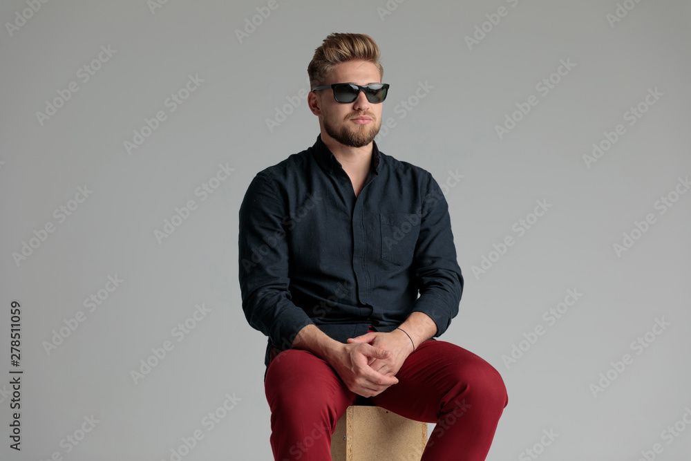 Neutral casual man looking away and holding his hands Neutral casual man looking away and holding his hands