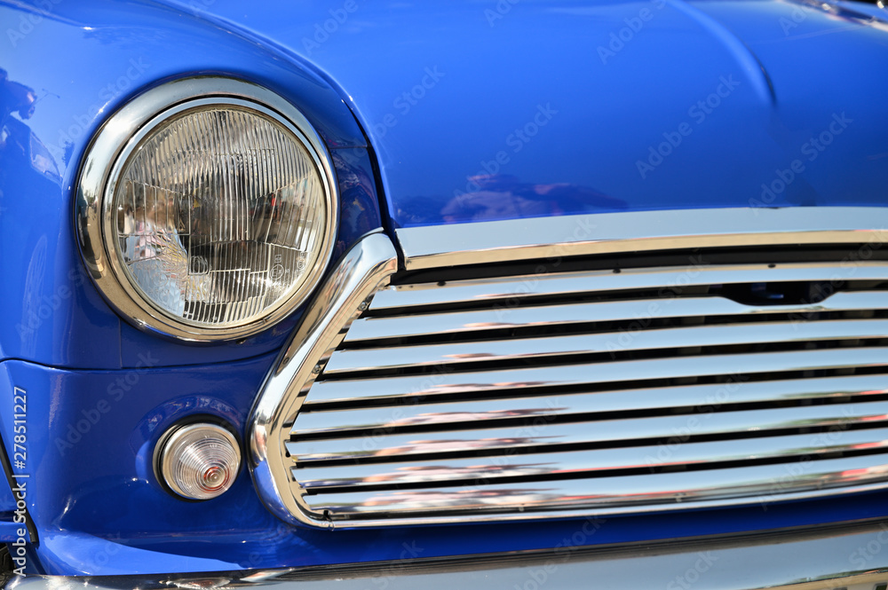 The front light of a vintage car.