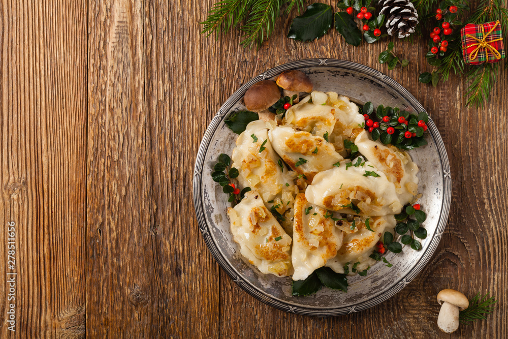 Traditional dumplings with cabbage and mushrooms. Christmas decoration. - obrazy, fototapety, plakaty 