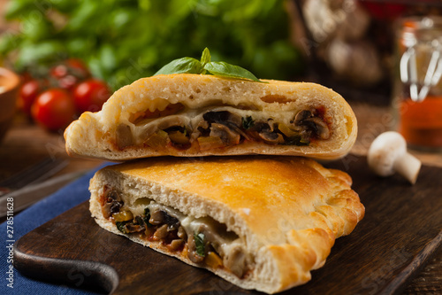 Obraz na płótnie Italian calzone with mushrooms and ham.