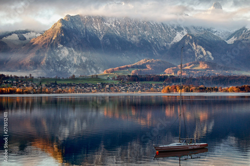 autumnal atmosphere at the Lake of Thoune with first snow photo