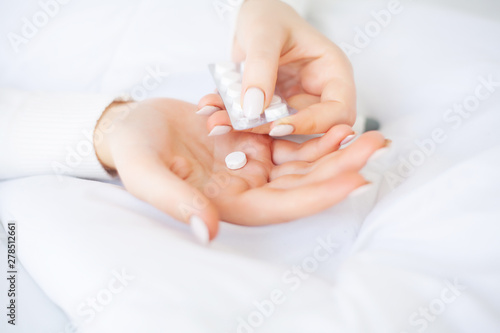 Valokuva Medical pills. Woman extracting a pill from the blister