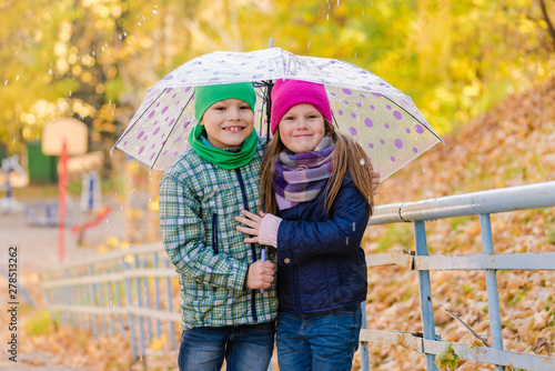 Two kids during autumn rain with umbrella © o_lypa