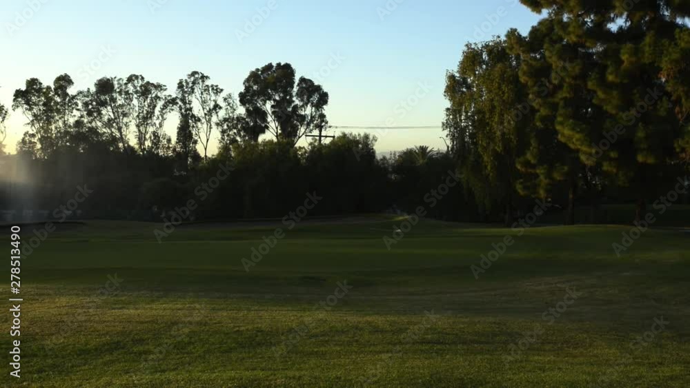 Beautiful sunset of Golf Course Sprinklers with flags and rainbows. Beautiful sunset of Golf Course Sprinklers with flags and rainbows.