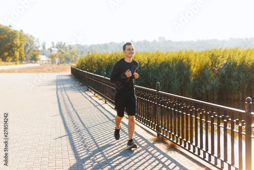 Photo of someone young man, running inn park, on the morning sunlight, sport concept